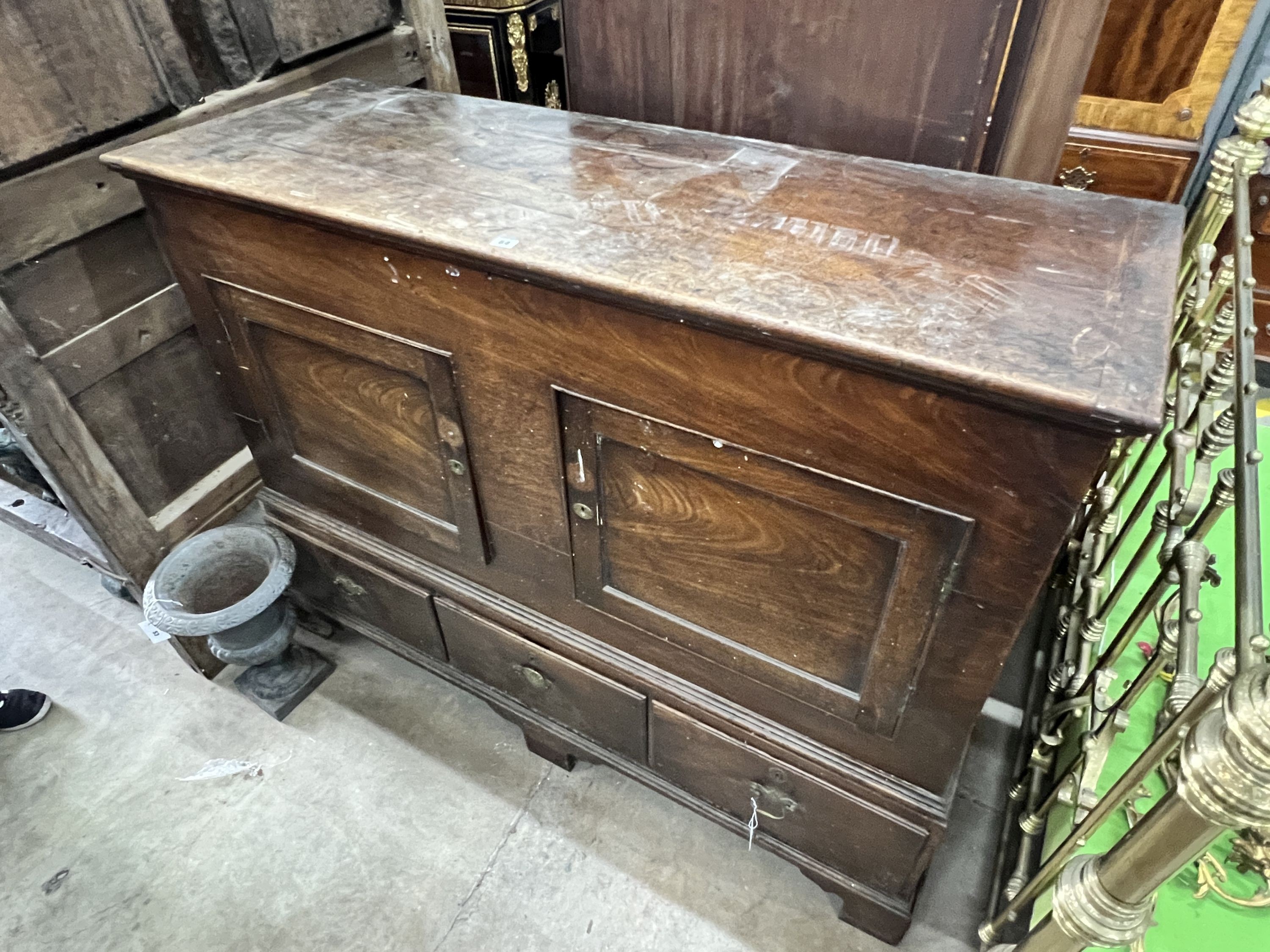 A mid 18th century fruitwood mule chest, adapted, with two panelled doors over three drawers, width 156cm, depth 57cm, height 124cm